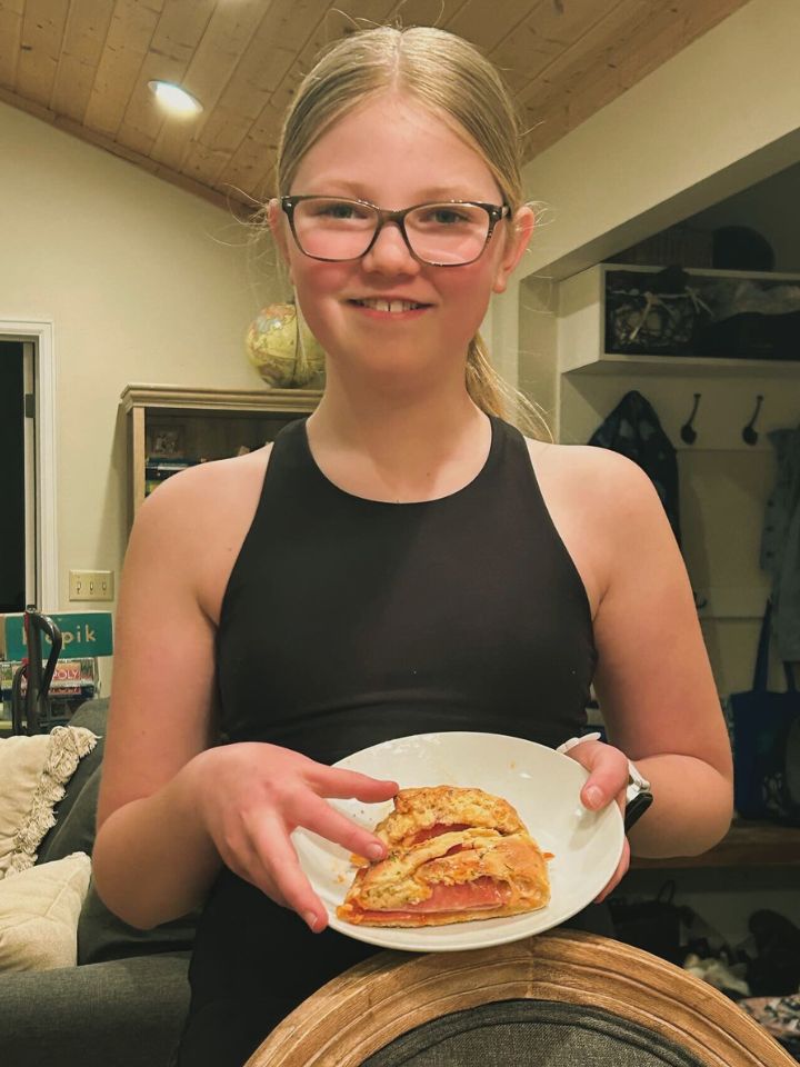home cooked stromboli simple meal planning came to fruition a girl holding a homemade stromboli on a plate